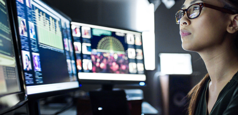 Forensic woman at computer screen