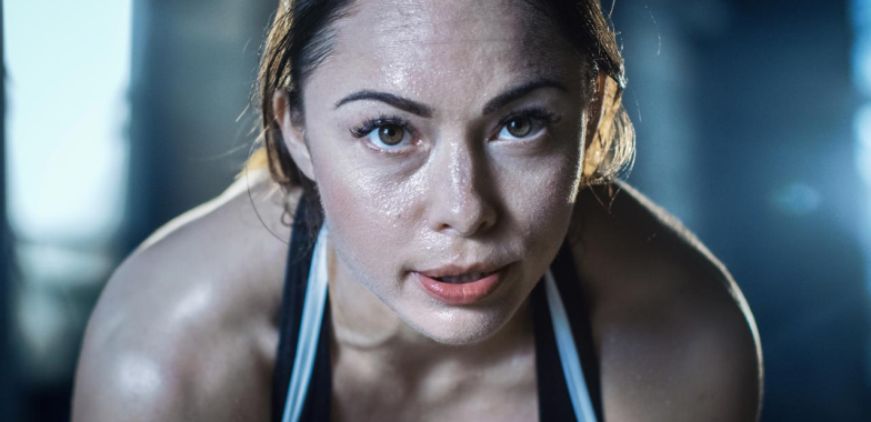 Female athlete close up with intense look during workout