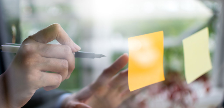 Writing on post it note on glass