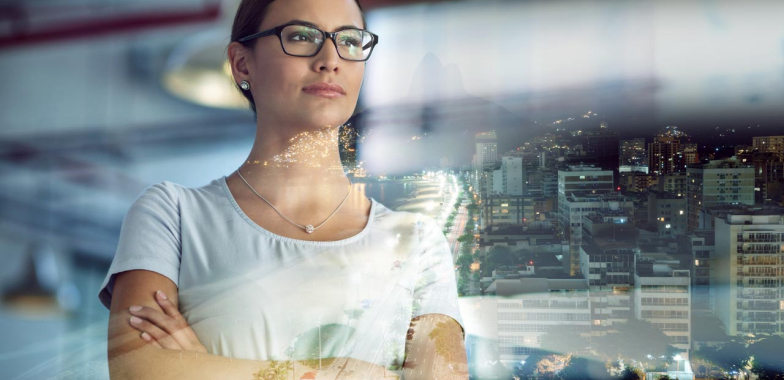 Woman in an office looking though window reflections