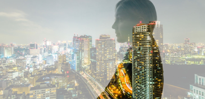 Side profile of woman with cityscape in background
