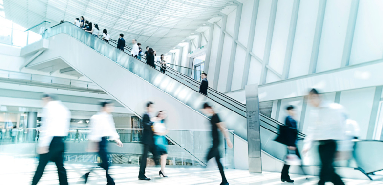 Foyer with escalator and people walking