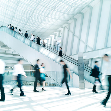 Foyer with escalator and people walking