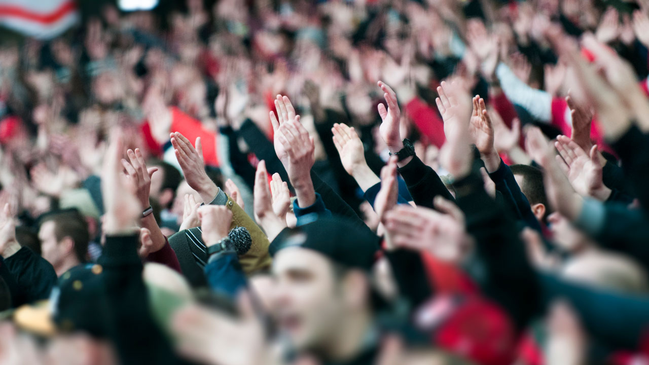 Large crowd with their hands in the air